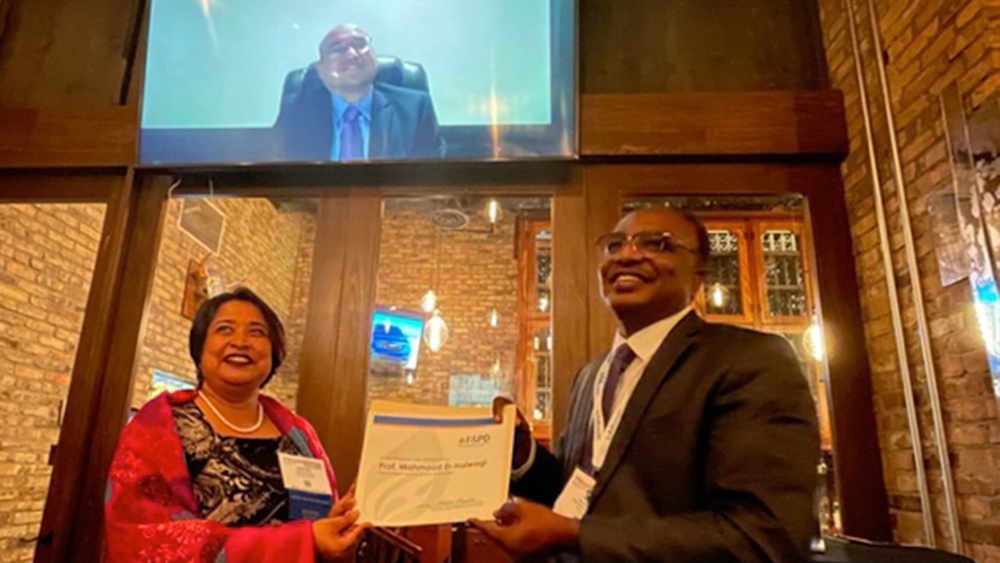 Dr. Nimir Elbashir (right) accepted the 2023 American Institute of Chemical Engineers’ Fuels and Petrochemicals Award on behalf of Dr. Mahmoud El-Halwagi, who attended virtually. The award was presented by Dr. Debalina Sengupta (left), past chair of the Fuels and Petrochemicals Division. | Image: Courtesy of Dr. Mahmoud El-Halwagi