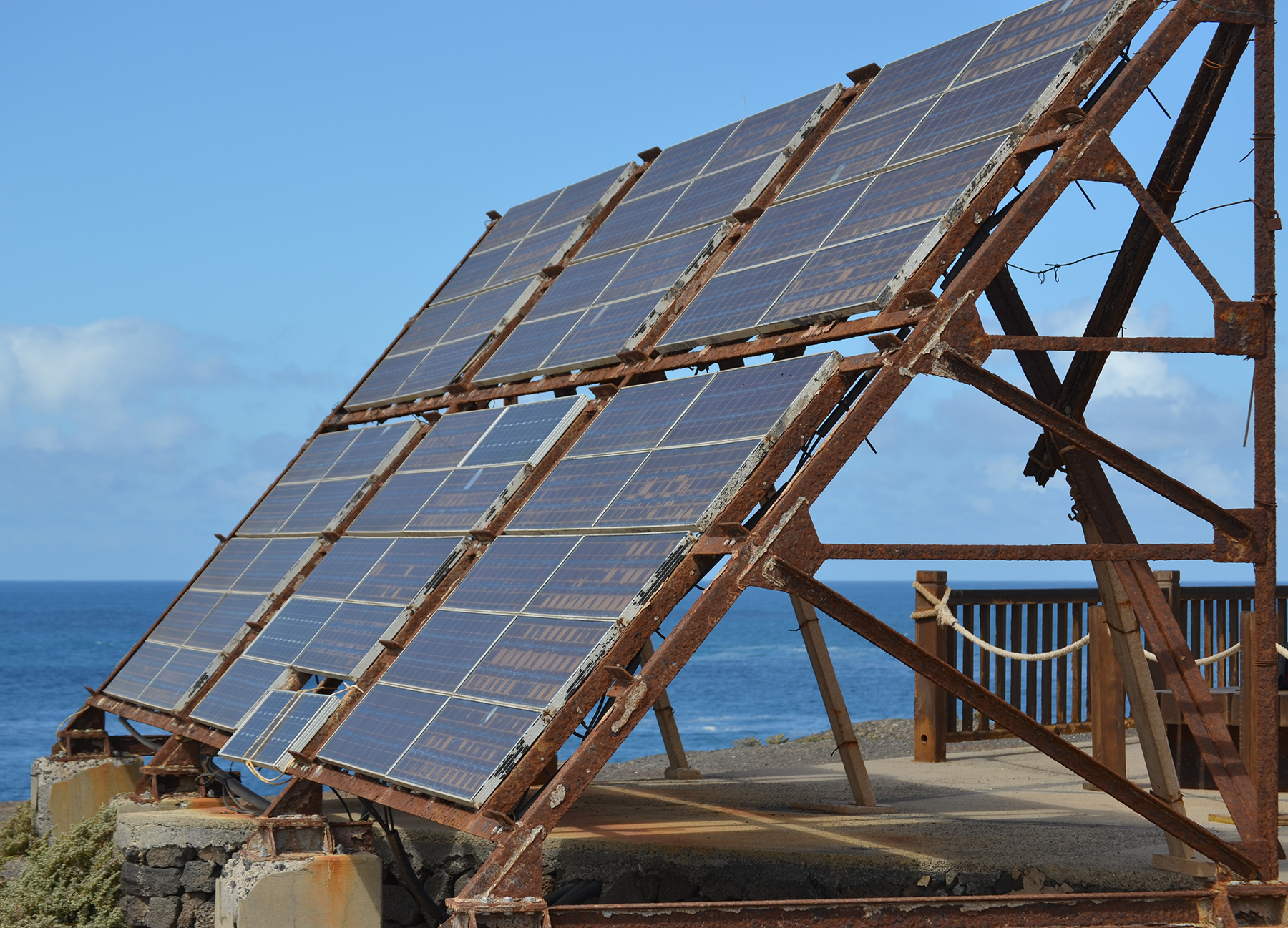 A solar panel array, damaged by sea spray and rust.