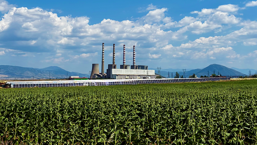 The Kardia Power Plant in the Western Macedonia Region, with solar panels and crops in the foreground.