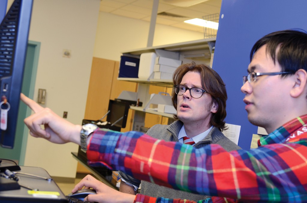 Dr. B.A. Wilhite and doctoral student Haomiao Zhang discuss experimental results